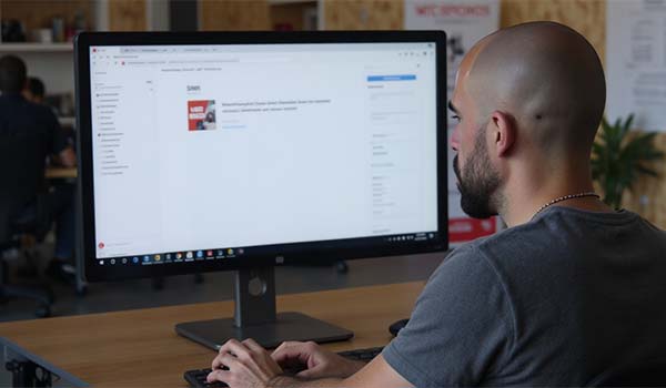 Alvaro Torres reviewing a WordPress form on a desktop monitor and fixing error messages